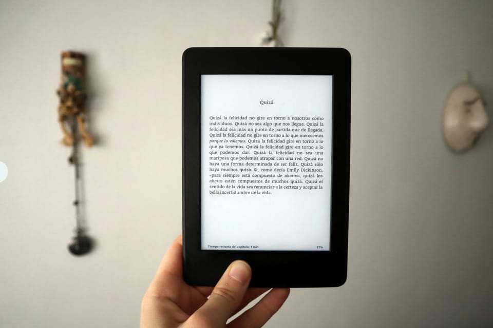 Photo of a man holding a Kindle